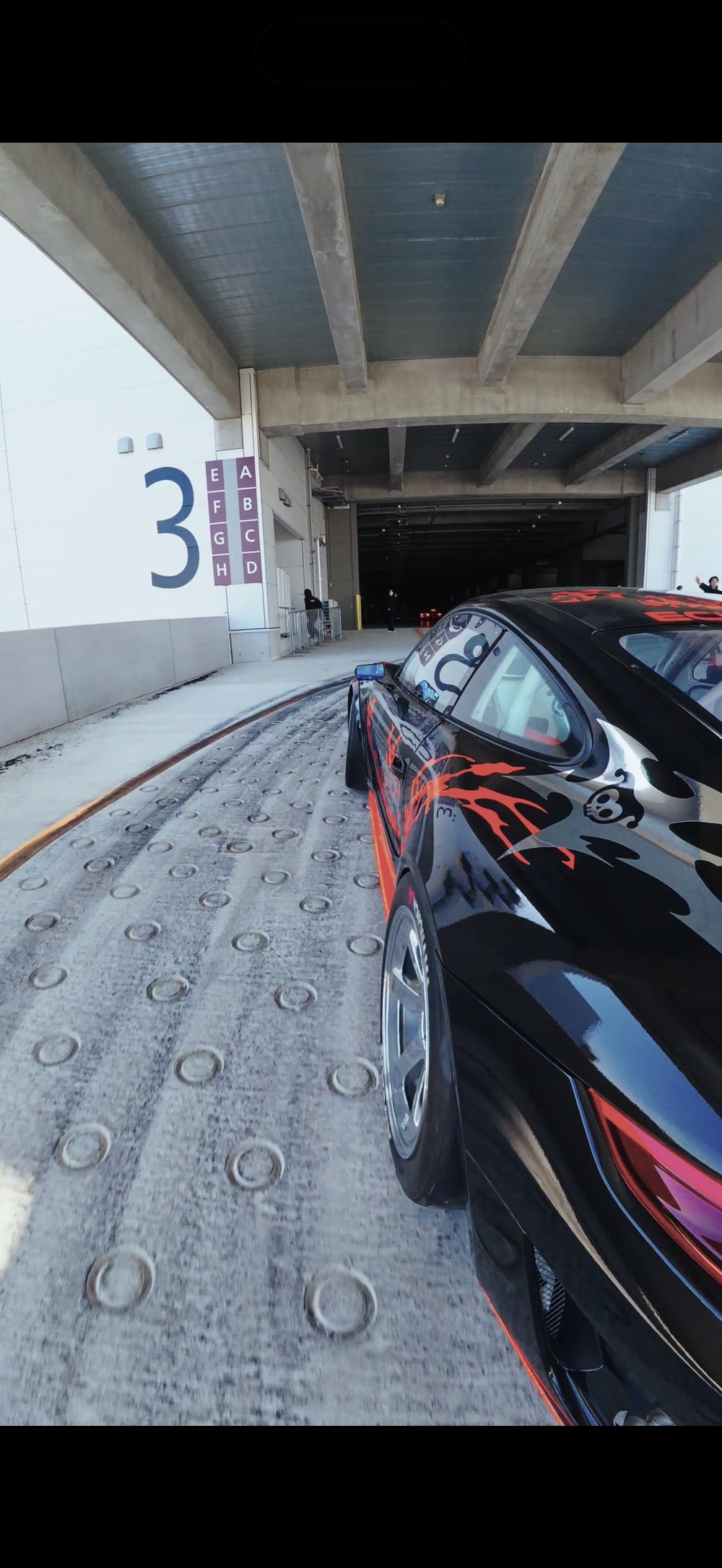 Black and red REVENANT beside pit garage 3