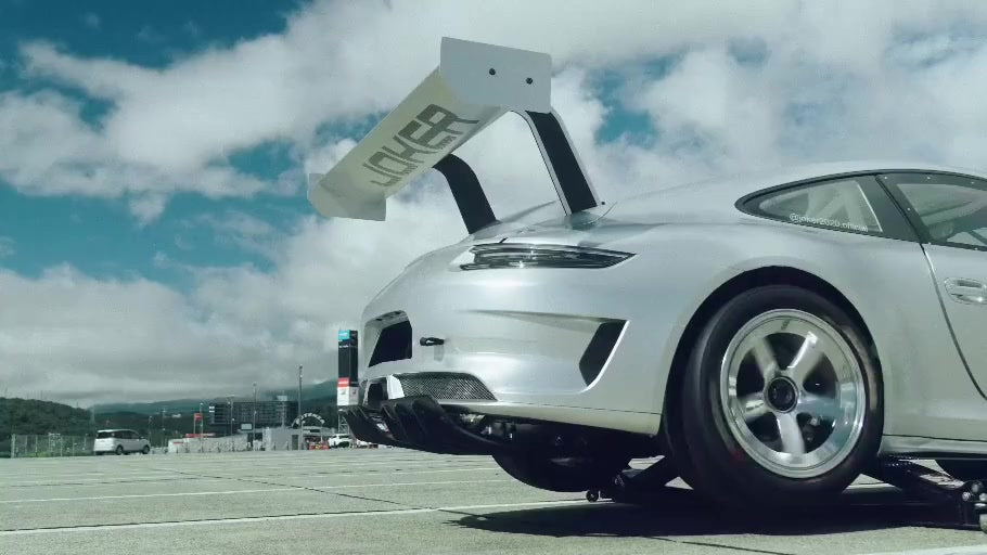 Rear three-quarter view of silver REVENANT at Fuji Speedway